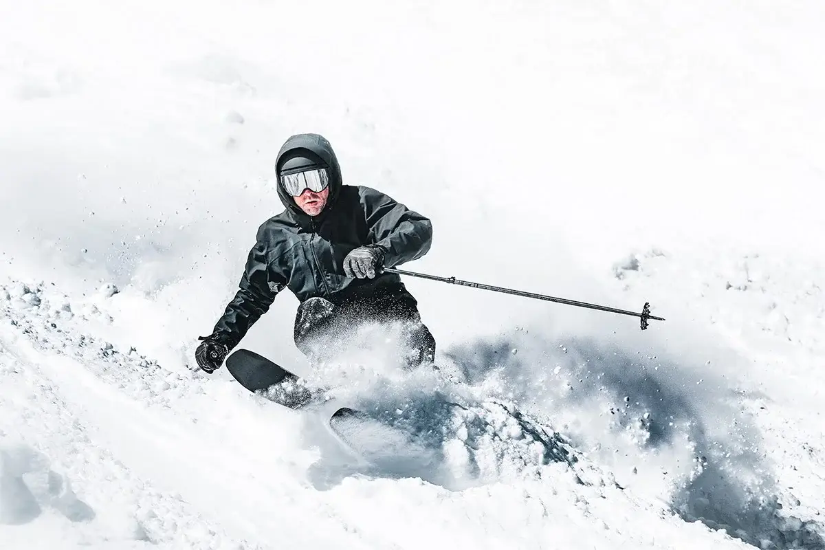 Skier carving through deep powder snow