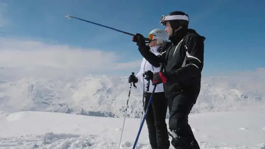 A professional skier testing equipment on a steep, snowy mountain.