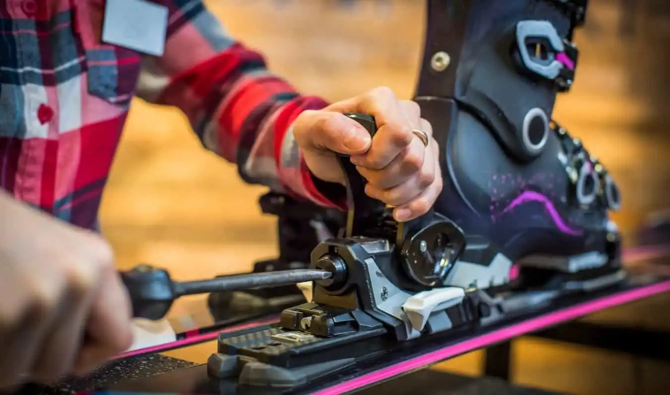 A close-up shot of a designer making final adjustments to a ski binding.