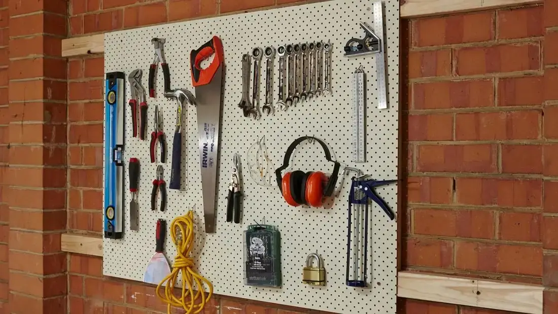 Tools hanging neatly on a workshop wall.