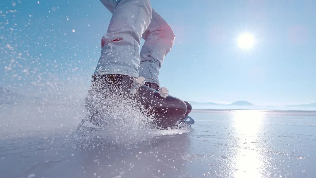 Close-up of ice skates on a frozen lake