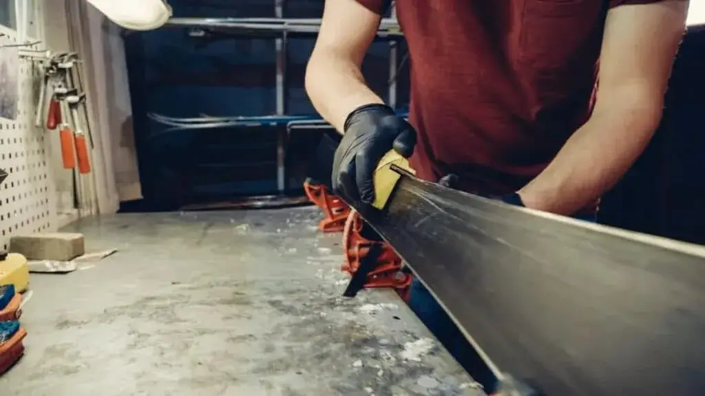 Detailed view of a ski edge being sharpened.