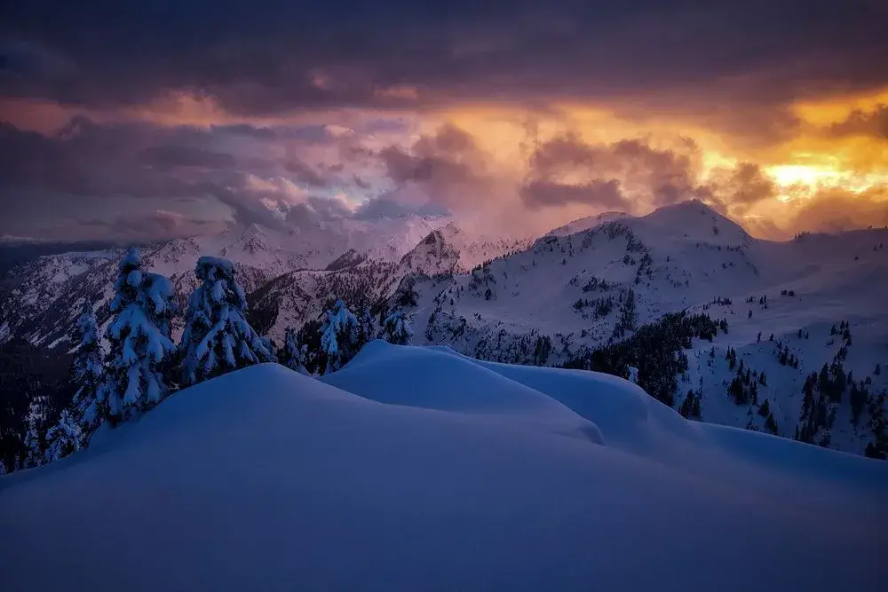 Sunset reflecting off a snowy mountain face.